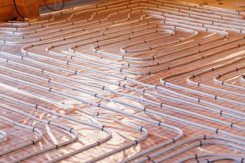 image of hot water tubes being placed for underfloor radiant heating