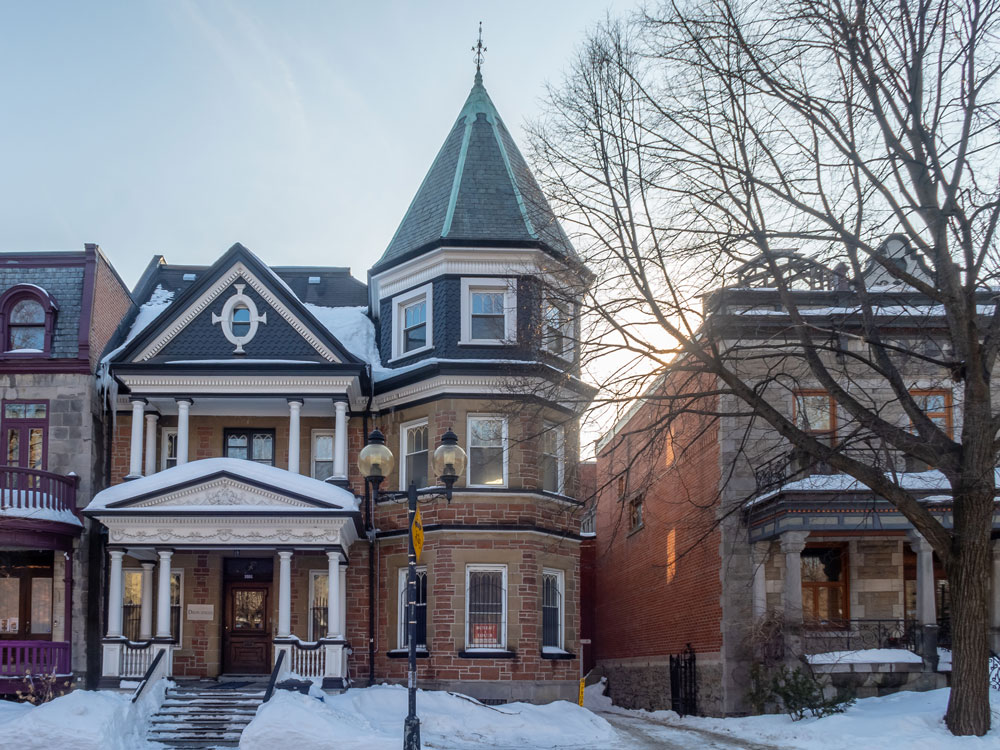 tall three story victorian home in the snow 